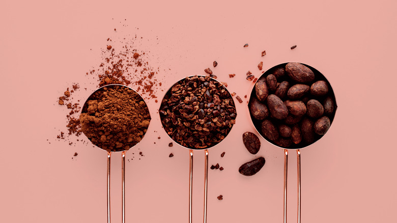 Measuring cups filled with cocoa beans