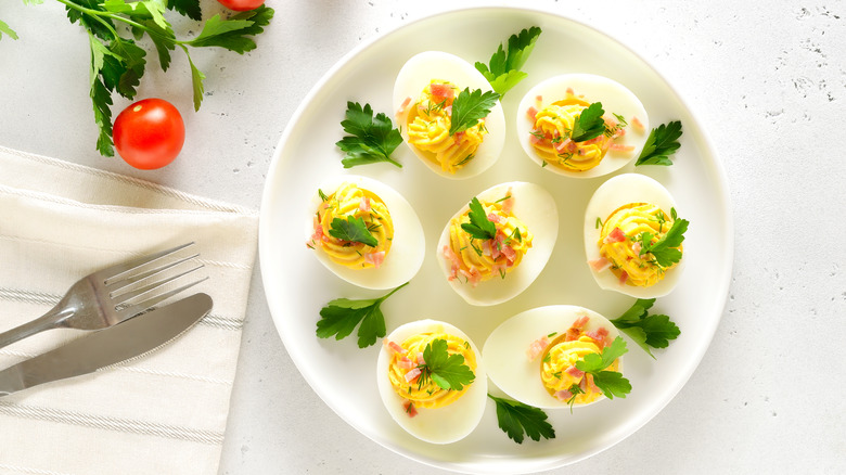 Deviled eggs on a plate garnished with cilantro