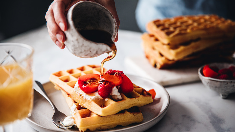 maple syrup poured over waffles 