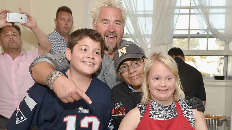 Guy Fieri standing with children