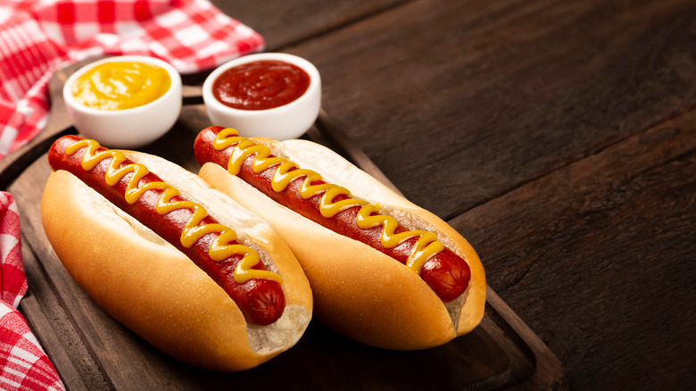 Hot dogs on a table with ketchup