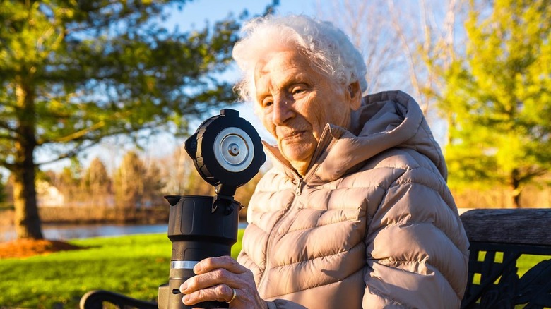 Elderly woman drinking from Brümachen