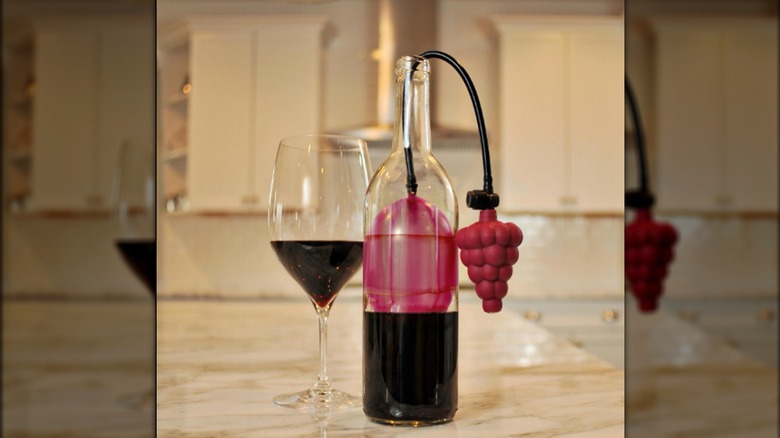 wine balloon aka air cork with bottle and glass of red wine