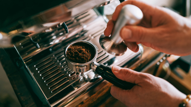 Person preparing espresso shot