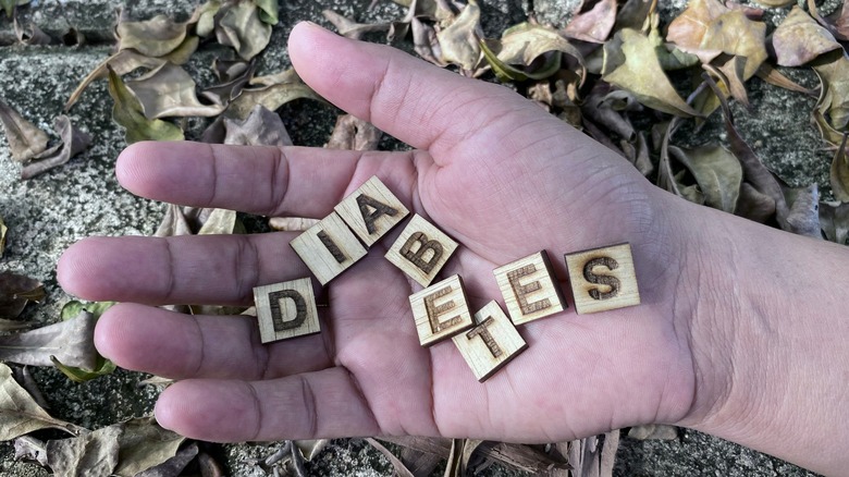 Scrabble pieces spelling diabetes in hand