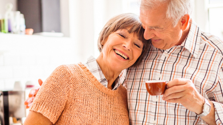 Joyous elderly couple enjoying coffee