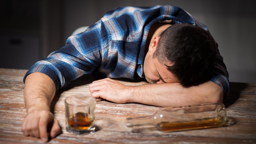 A man passes out on the bar