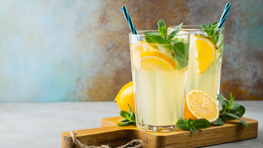 Glasses of lemonade on wooden board