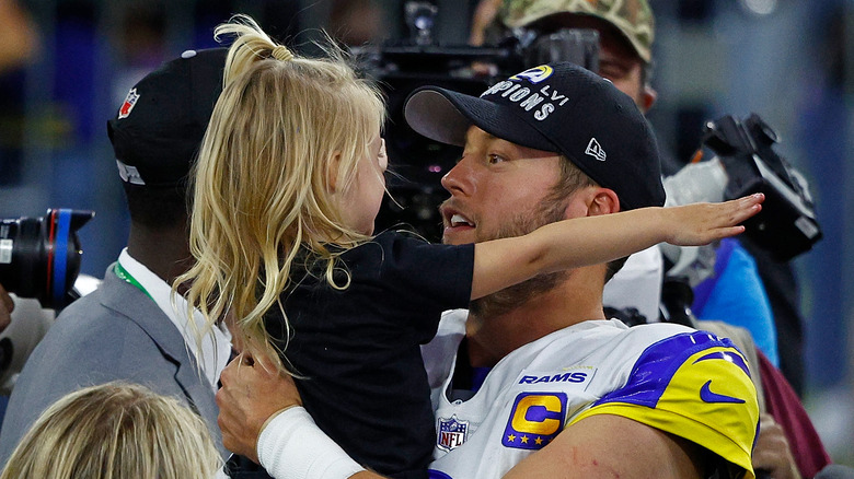 Matthew Stafford holding his daughter