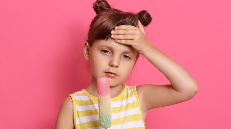 little girl with ice cream headache