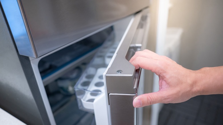 hand opening fridge