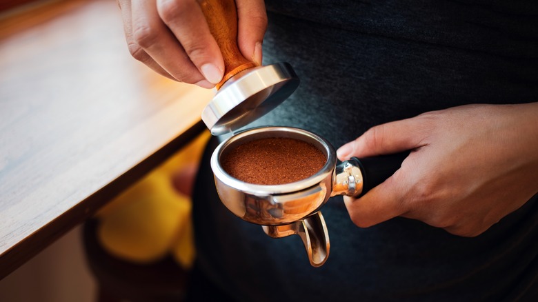 Barista tamping espresso