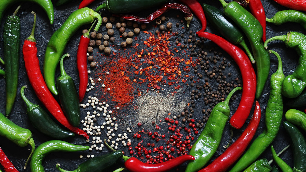 A variety of peppers on a black background