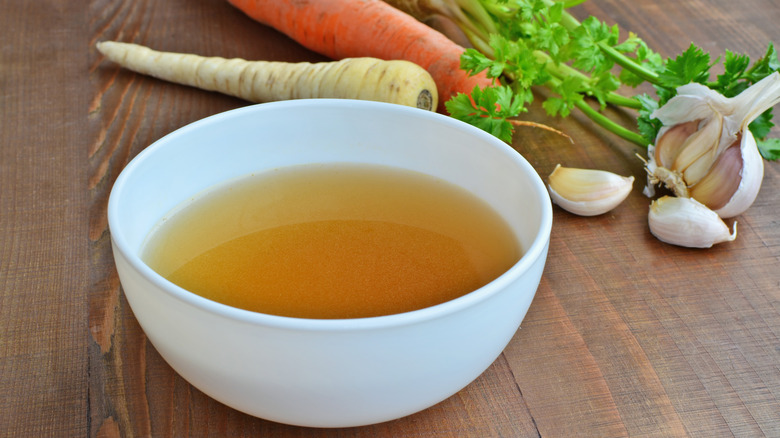 Vegetable Stock in a white bowl with carrots