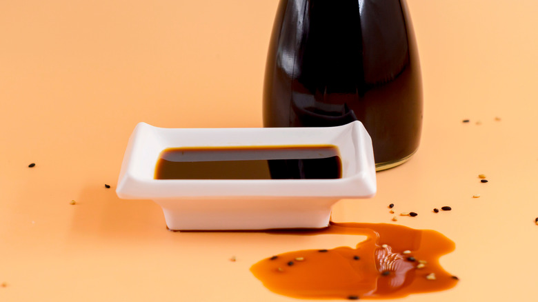 Bottle of soy sauce with a small dish on the side