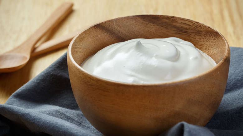 A wooden bowl of yogurt