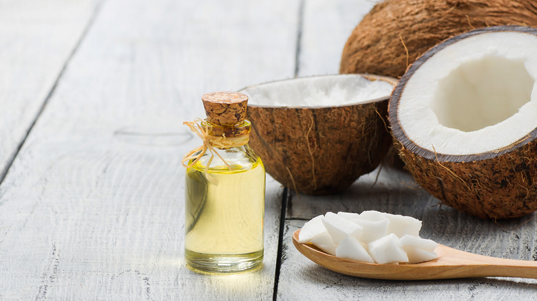 A jar of coconut oil and coconuts