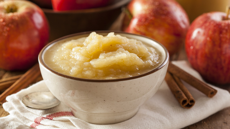 A bowl of applesauce with apples and cinnamon