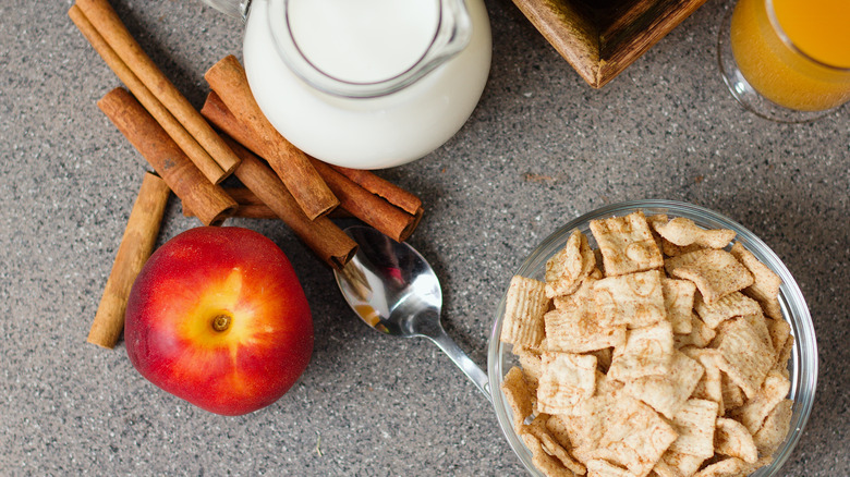 Cereal with apple and cinnamon sticks