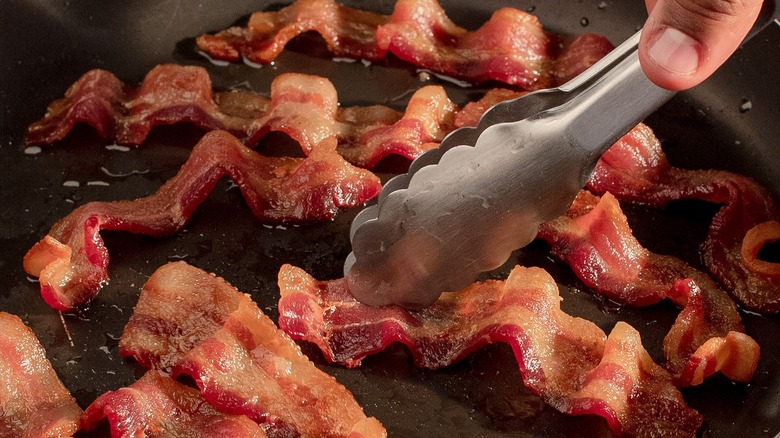 bacon sizzling in pan