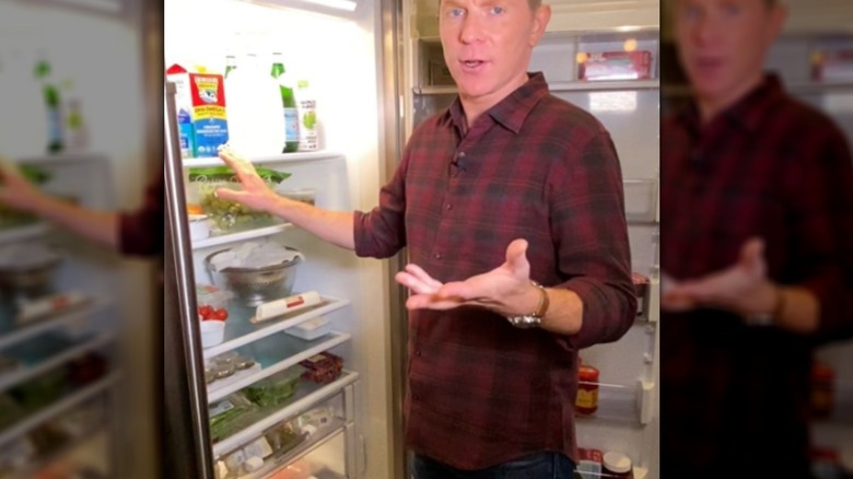 Bobby Flay standing by his refridgerator