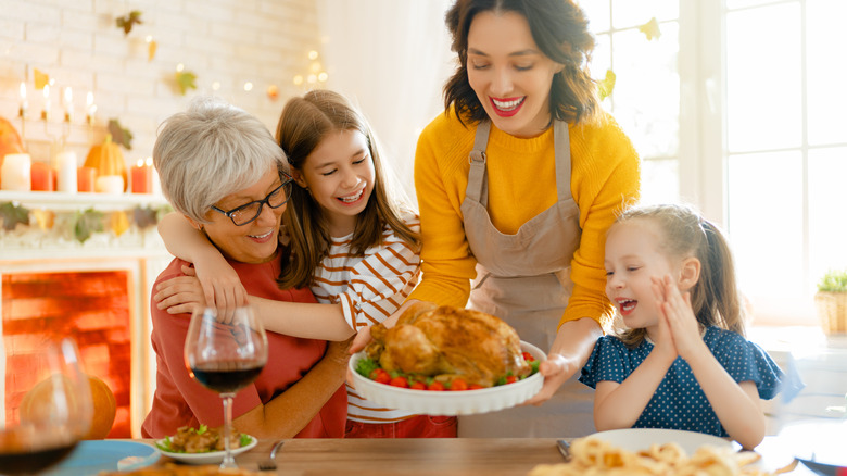 woman serving turkey on Thanksgiving