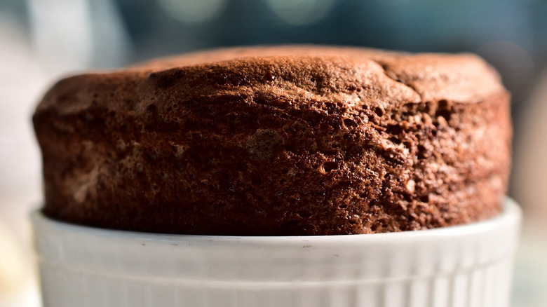 Tall chocolate souffle in a ramekin