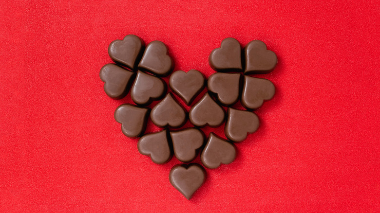 Chocolate in the shape of a heart on red background