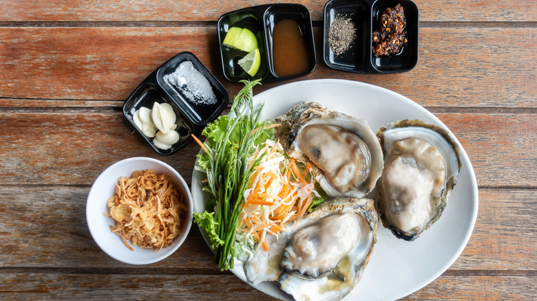 A plate of oysters with accompaniments