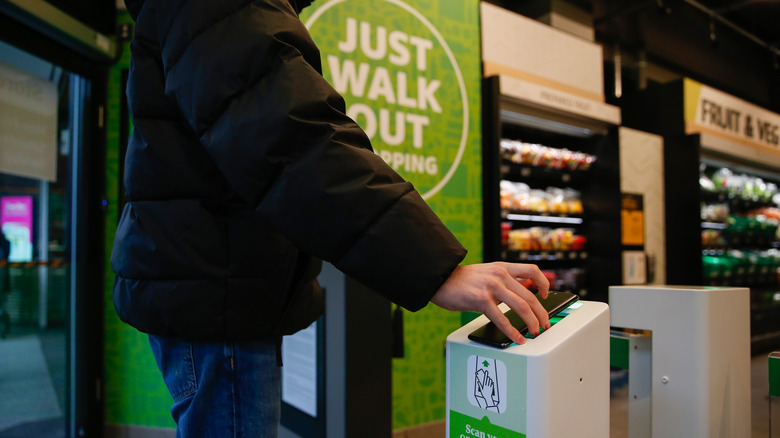 A customer scans into a cashierless Amazon Fresh store