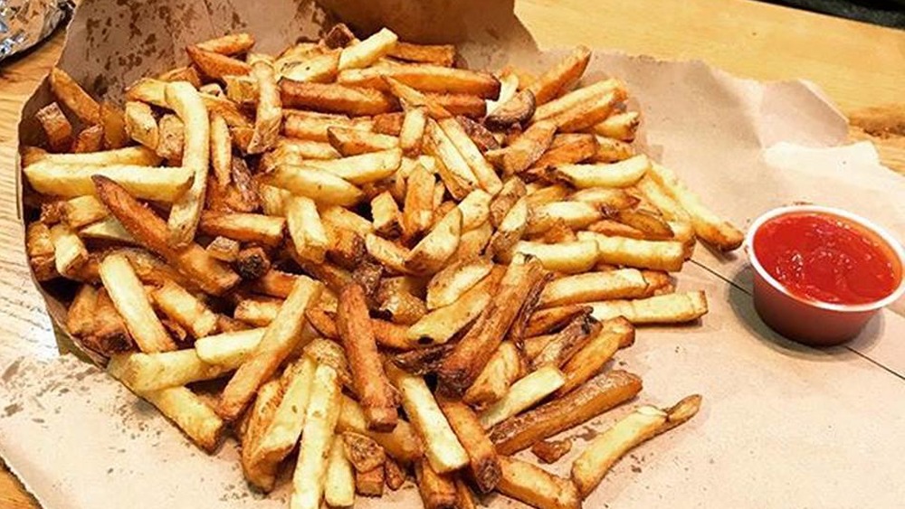 Bag of fries spills out from Five Guys