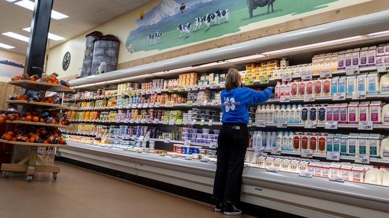 Trader Joe's worker stocking milk