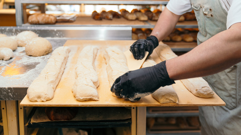 baker shaping bread dough