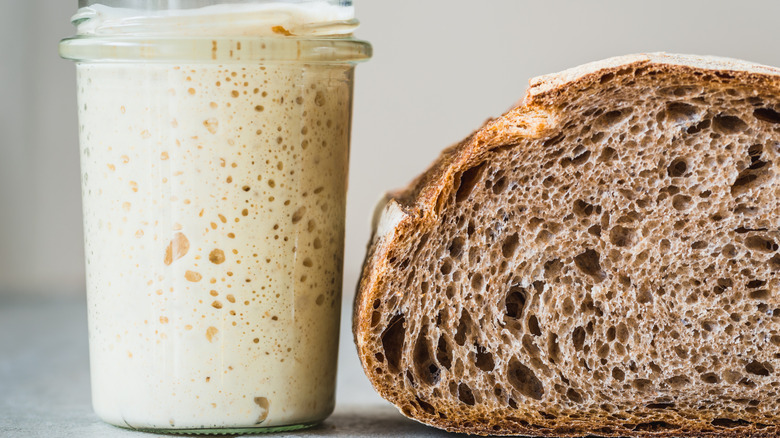 sourdough starter next to loaf