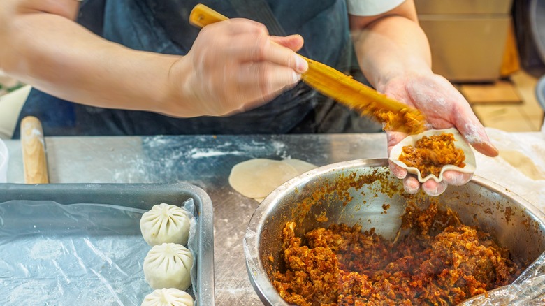 Chef filling dumplings