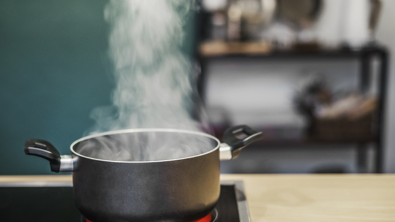 A pot on a stove steaming