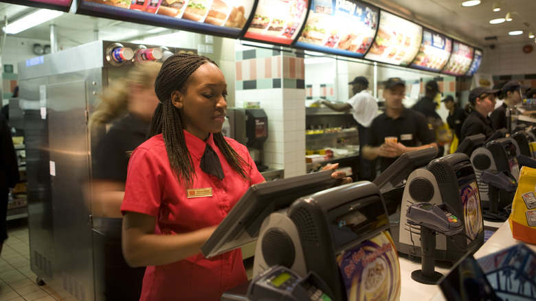 fast food employee at register