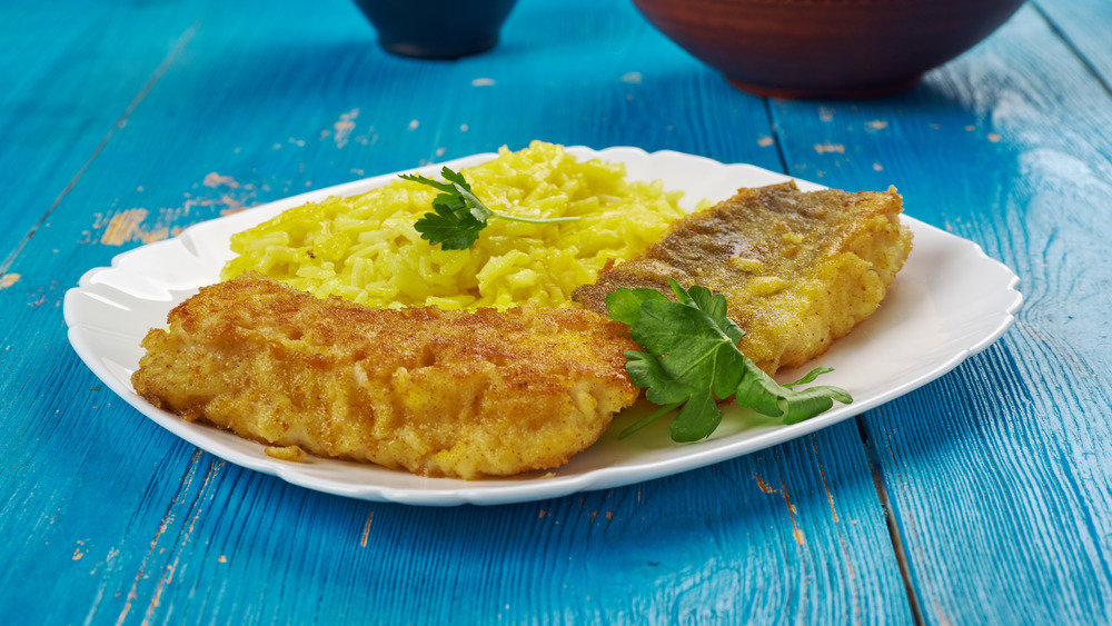 Sabzi polo ba mahi on white plate