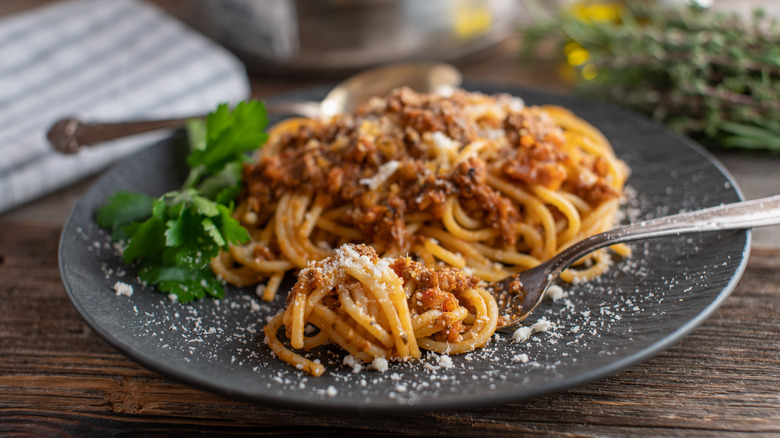 plate of spaghetti bolognese with fork