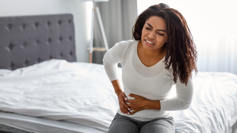 woman sitting with upset stomach