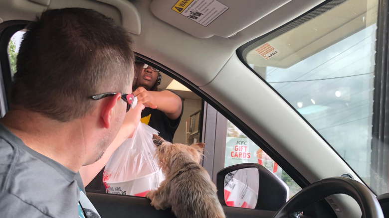 man getting kfc drive through order