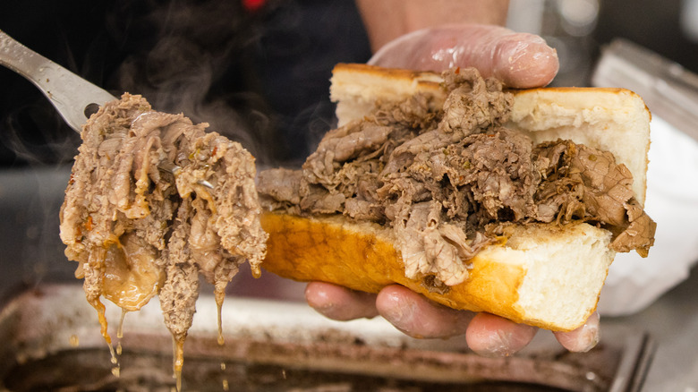 team member puts Italian beef into roll