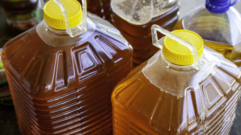 Plastic bottles filled with brown, old cooking oil