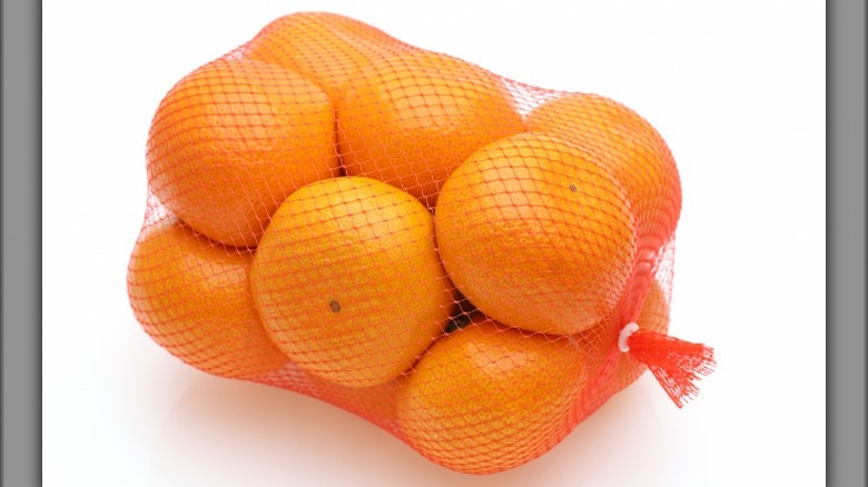 Oranges in an orange/red bag