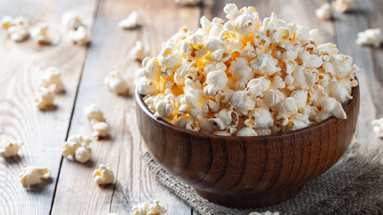 A wooden bowl of popcorn