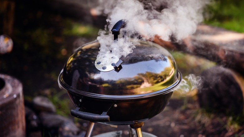 Closed grill with smoke escaping