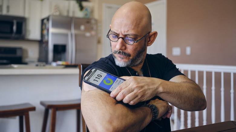 man checking blood sugar levels