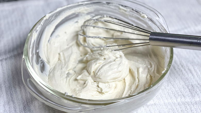 whipped soft cheese in a clear mixing bowl