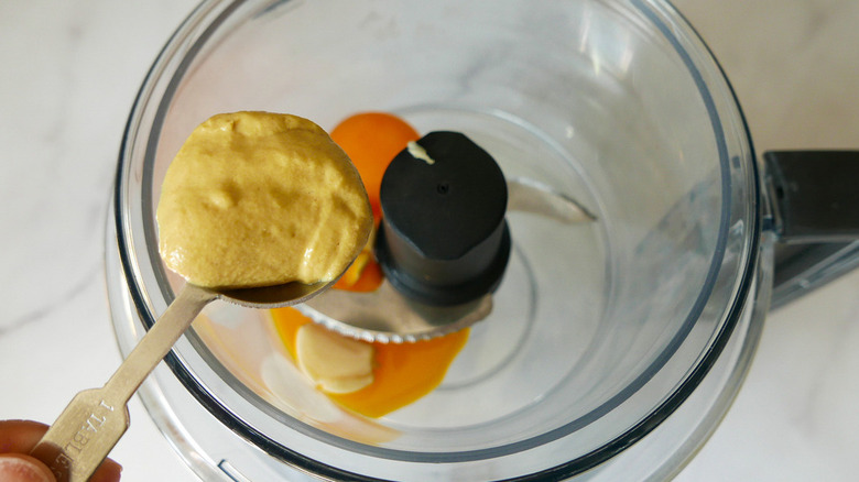 mustard going into food processor