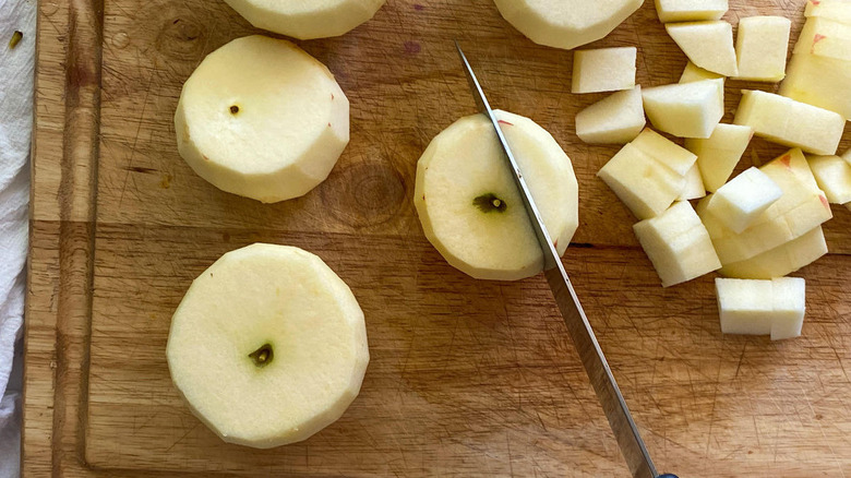 peeled apples on cutting board